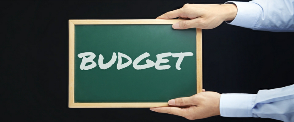 Hands holding blackboard with text budget