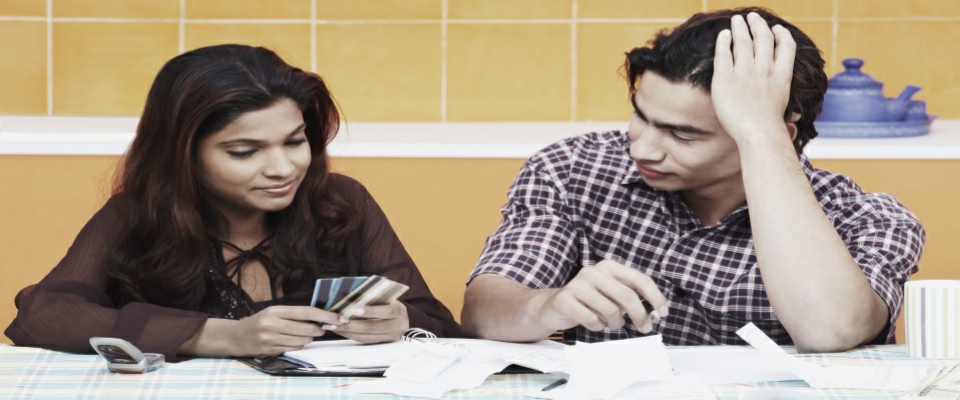 Close-up of a young couple looking at credit cards