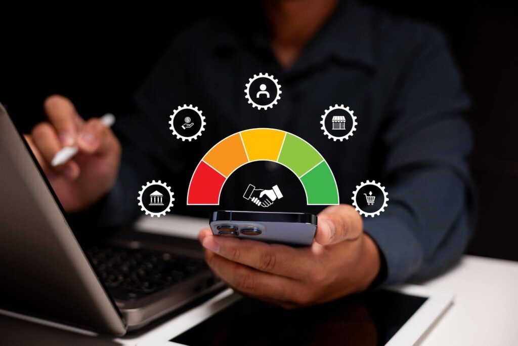 a person using a phone and a credit score gauge
