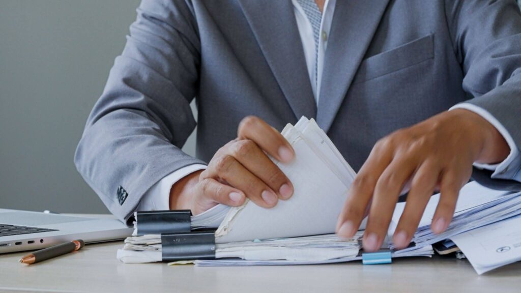 a businessman checking multiple documents