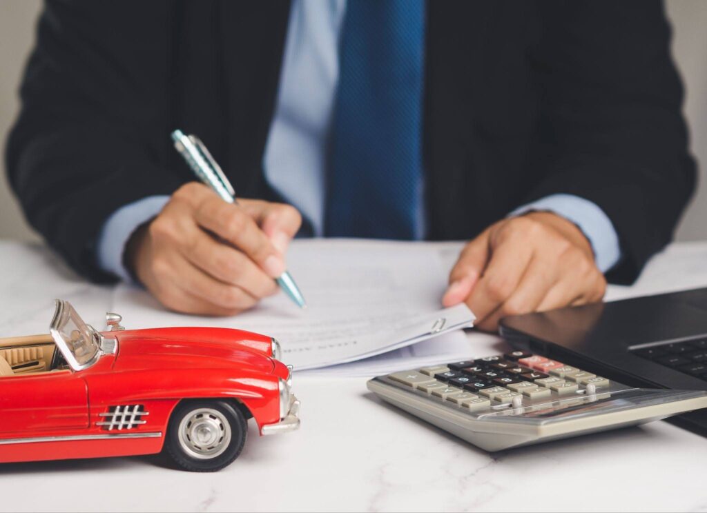 a man is signing a contract for a title loan