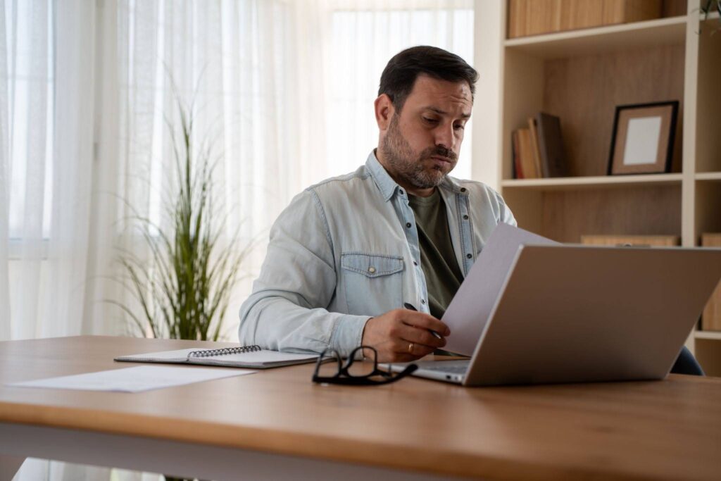 a tired man considering taking out emergency funeral loans