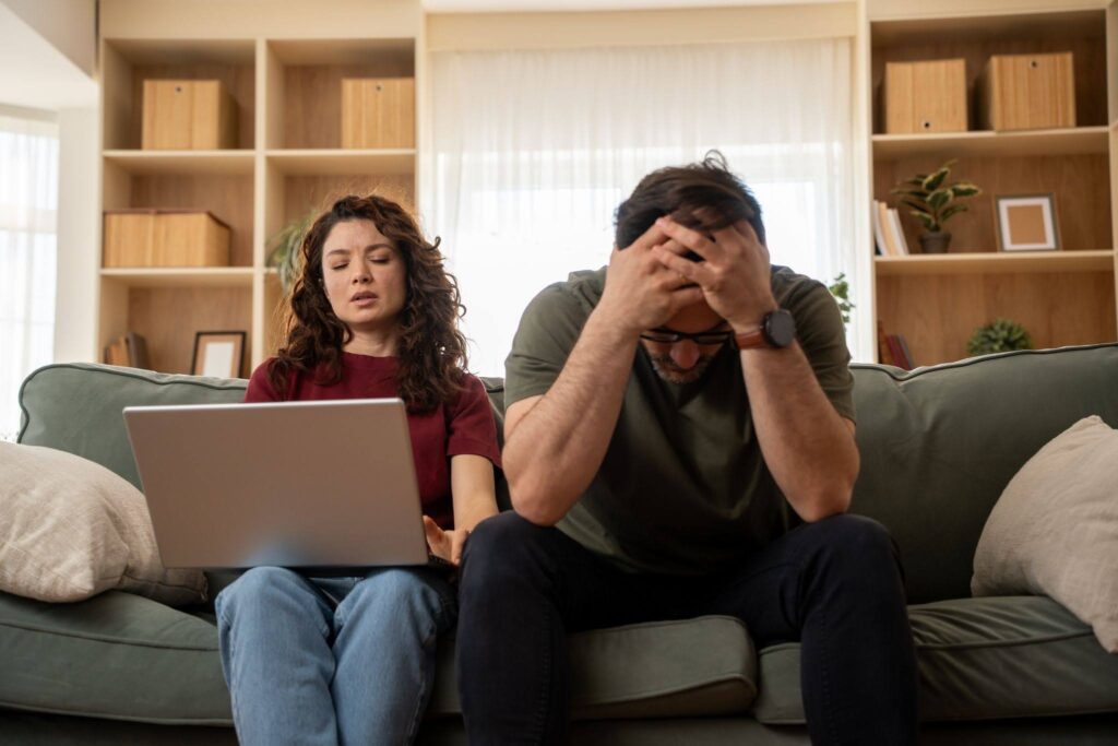 stressed couple checking funeral expenses