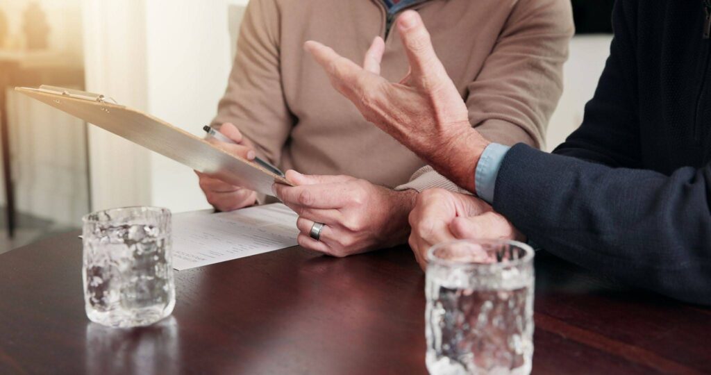 a man is discussing a title loan contract with an advisor