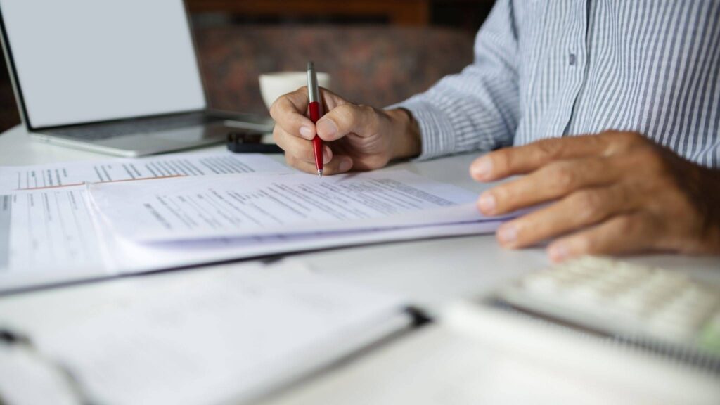 a man is carefully reviewing a car title loan contract
